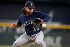 Seattle Mariners third baseman Eugenio Suarez fields a ground ball by Texas Rangers' Josh Jung in the first inning of a baseball game, Sunday, Sept. 24, 2023, in Arlington, Texas. Jung was thrown out at first base on the play. (AP Photo/Tony Gutierrez)
