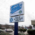 A sign in front of the AquaSox front office references the upcoming Everett City Council vote on a sum of $1.1 million to give to outside contractors to help upgrade a new stadium on Wednesday, Nov. 29, 2023 in Everett, Washington. (Olivia Vanni / The Herald)