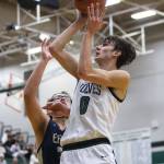 Jacksons Ryan Mcferran jumps to make a layup during the game against Arlington on Tuesday, Nov. 28, 2023 in Everett, Washington. (Olivia Vanni / The Herald)