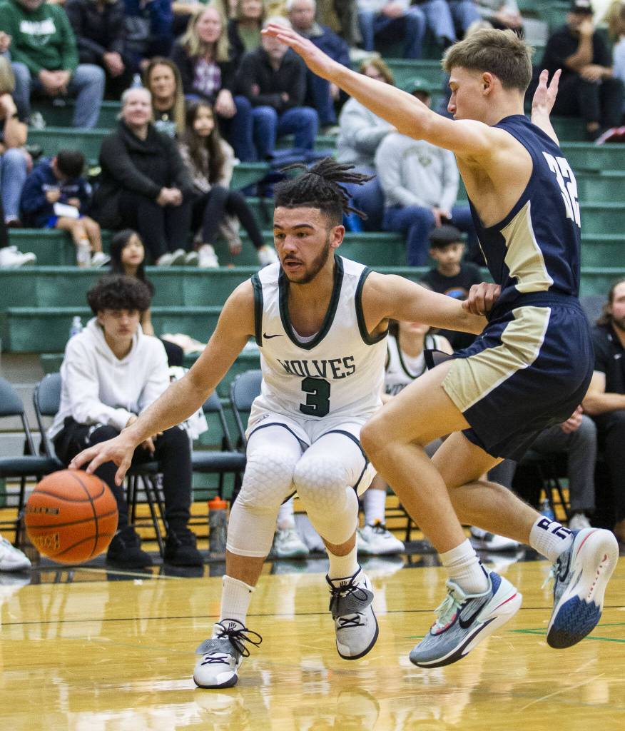 Jacksons Trey Hawkins tries to maneuver around Arlingtons Kaid Hunter during the game on Tuesday, Nov. 28, 2023 in Everett, Washington. (Olivia Vanni / The Herald)