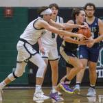 Jacksons Drew Pepin gets the ball stolen away by Arlingtons Silas Miller during the game on Tuesday, Nov. 28, 2023 in Everett, Washington. (Olivia Vanni / The Herald)