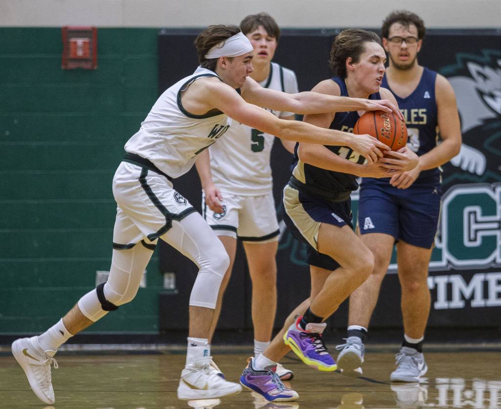 Jacksons Drew Pepin gets the ball stolen away by Arlingtons Silas Miller during the game on Tuesday, Nov. 28, 2023 in Everett, Washington. (Olivia Vanni / The Herald)