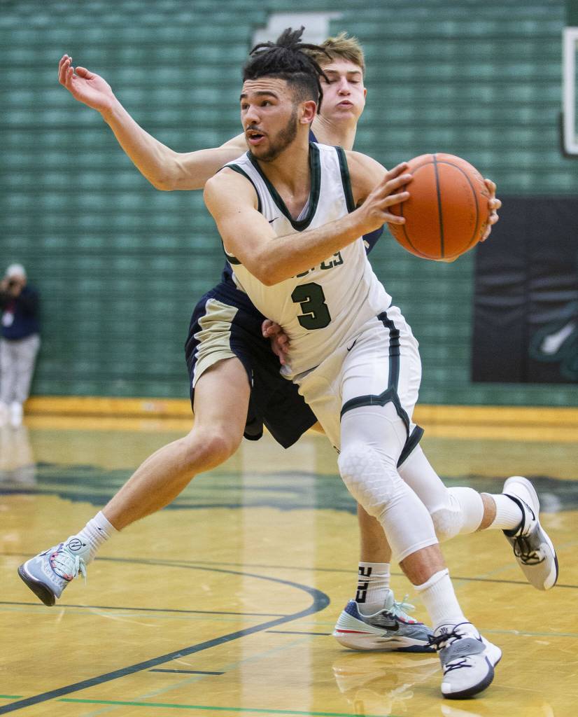 Jacksons Trey Hawkins drives to the hoop during the game against Arlington on Tuesday, Nov. 28, 2023 in Everett, Washington. (Olivia Vanni / The Herald)
