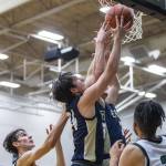 Multiple Arlington players leaps in the air for a rebound during the game against Jackson on Tuesday, Nov. 28, 2023 in Everett, Washington. (Olivia Vanni / The Herald)