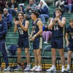 The Arlington bench react to a score during the game against Jackson on Tuesday, Nov. 28, 2023 in Everett, Washington. (Olivia Vanni / The Herald)
