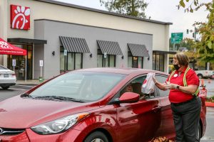 An order is delivered to one of the first cars at Chick-Fil-A's store in Marysville on its opening day Thursday on May 21, 2020. (Kevin Clark / The Herald)