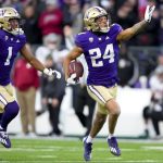 Washington safety Makell Esteen (24) celebrates making an interception against Washington State with cornerback Jabbar Muhammad (1) during the second half of an NCAA college football game Saturday, Nov. 25, 2023, in Seattle. (AP Photo/Lindsey Wasson)