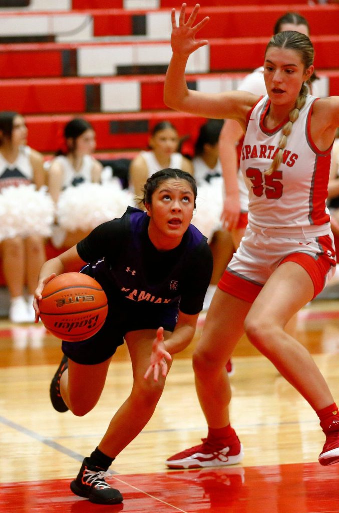 Kamiak senior Vivian Mawudeku gets by a defender on the baseline against Stanwood on Thursday, Nov. 30, 2023, at Stanwood High School in Stanwood, Washington. (Ryan Berry / The Herald)