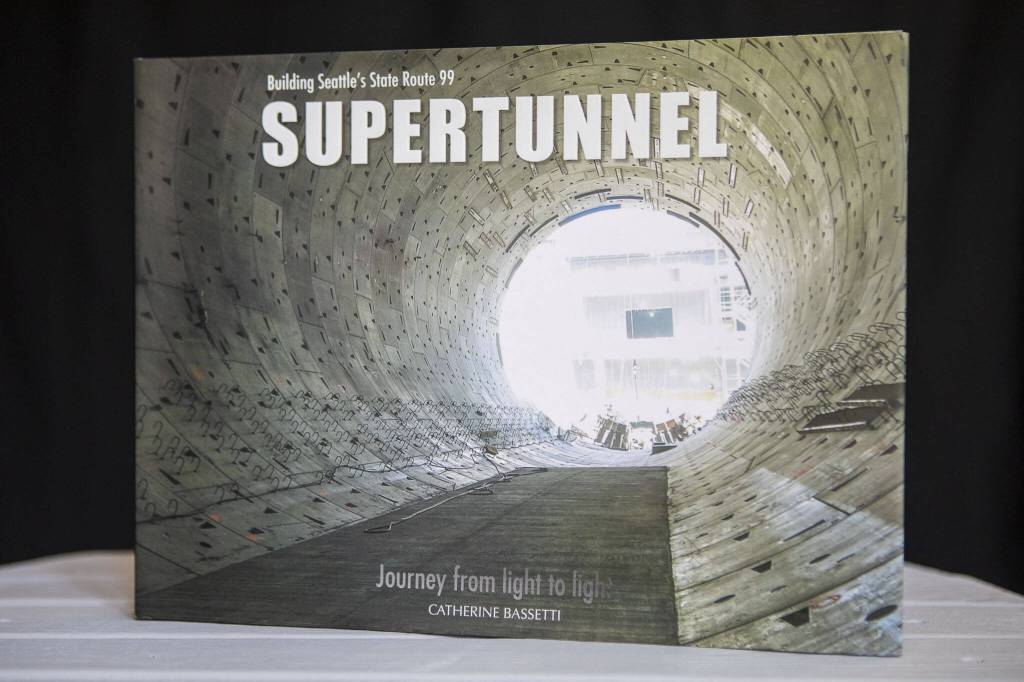 Catherine Bassettis book Building Seattles State Route 99 Supertunnel: Journey from Light to Light in her home studio in Shoreline, Washington on Friday, May 19, 2023. (Annie Barker / The Herald)