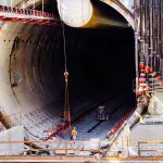 An engineer walks out of the mouth of the Seattle tunnel, at the south launch zone where the tunnel boring machine began it's journey mining under the city's downtown. The tunnel is the largest diameter in the world to date and will have dual level roadways running north and south, replacing the aging Alaskan Way Viaduct along the waterfront.