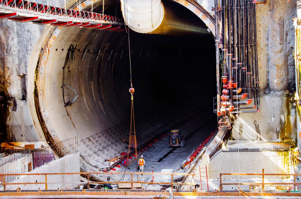 An engineer walks out of the mouth of the Seattle tunnel, at the south launch zone where the tunnel boring machine began it's journey mining under the city's downtown. The tunnel is the largest diameter in the world to date and will have dual level roadways running north and south, replacing the aging Alaskan Way Viaduct along the waterfront.