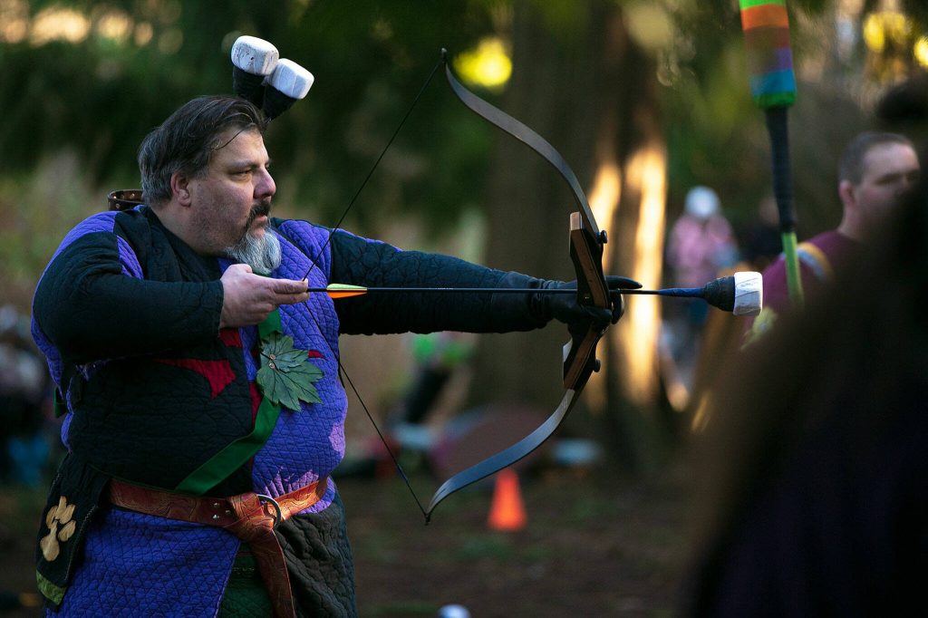 Brian Mann, persona Medzek, prepares to fire an arrow during a weekly meeting of the Amtgard LARPing group The Hollow on Jan. 29, at McCollum Park. (Ryan Berry / The Herald)