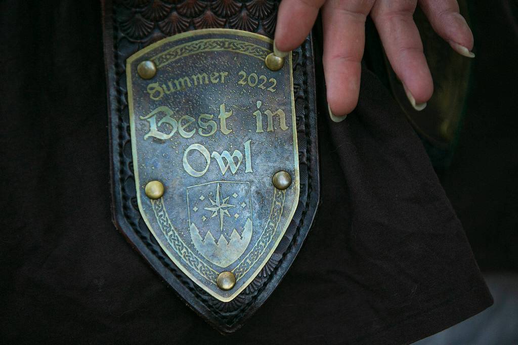Dane Pischke, persona Matrix, shows off a crafting award won the previous year during a weekly meeting of the Amtgard LARPing group The Hollow on Jan. 29, at McCollum Park. (Ryan Berry / The Herald)