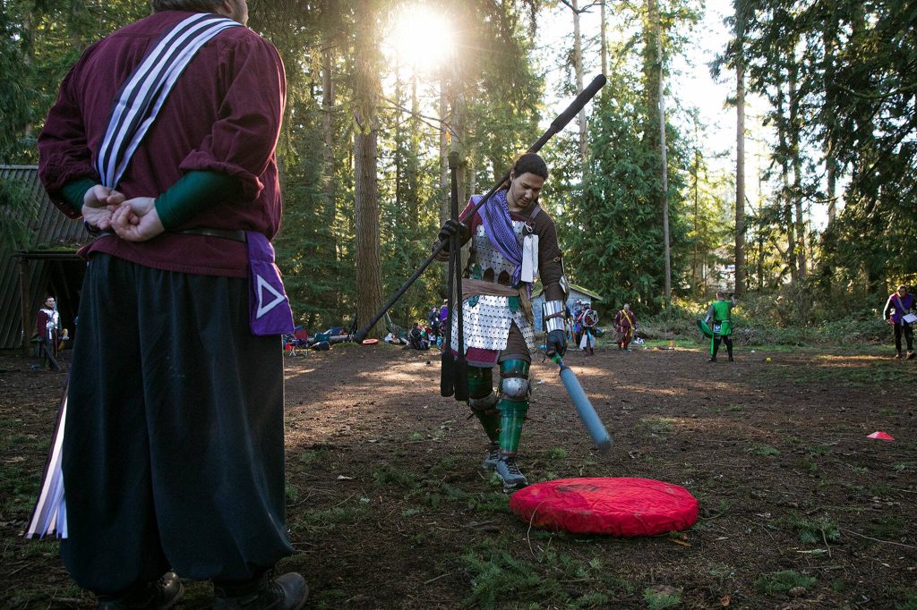 William Yip, persona Drusk, rings the bell uncontested during a 4-on-4 tournament at a weekly meeting of the Amtgard LARPing group The Hollow on Jan. 29, at McCollum Park. (Ryan Berry / The Herald)