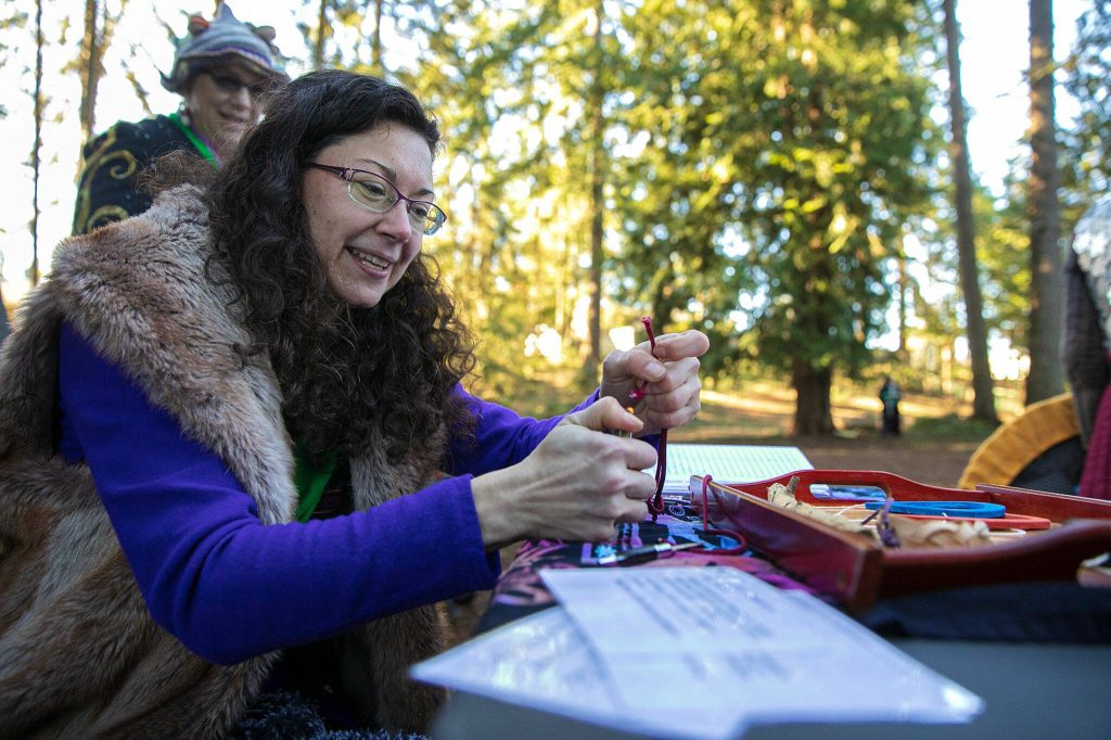 Elizabeth Moulin-Franco, persona Sweetleaf, works on crafting some prizes for a tournament during a weekly meeting of the Amtgard LARPing group The Hollow on Jan. 29, at McCollum Park. (Ryan Berry / The Herald)