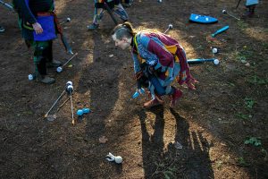 Rowen Scout, persona Stoat, snags an ice spell from the ground during a warmup round of "heavy object" at a weekly meeting of the Amtgard LARPing group The Hollow on Sunday, Jan. 29, 2023, at McCollum Park in Everett, Washington. (Ryan Berry / The Herald)