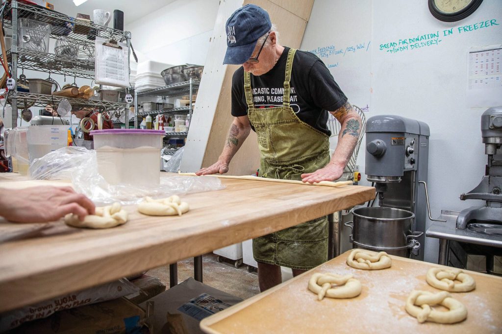 Lead bread baker Billy McCabe makes pretzels at Seabiscuit Bakery in Langley. (Annie Barker / The Herald)