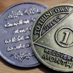 A one-month recovery coin earned by someone battling fentanyl addiction in March of 2022 is shown. (Kevin Clark / The Herald)