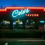 Classic neon-style lights illuminate the front of Coles Tavern. (Ryan Berry / The Herald)