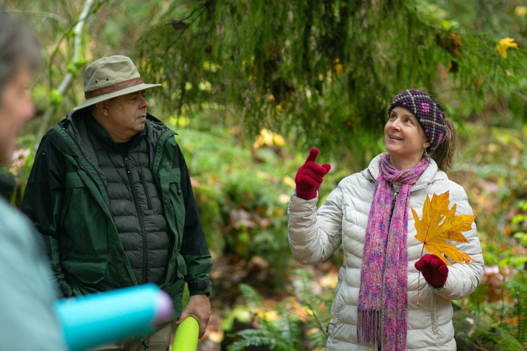 Jeanie, right, and James Pendleton take turns talking about their observations during a forest bathing session Sunday, Nov. 19, 2023, at Lord Hill Regional Park near Snohomish, Washington. (Ryan Berry / The Herald)