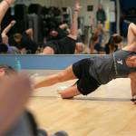 Instructor Gael Gebow checks her stopwatch while tracking her group’s exercises during her Boot Camp fitness class Monday, Nov. 13, 2023, at the YMCA in Everett, Washington. (Ryan Berry / The Herald)