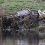 Remnants of a boat are visible along the riverbank of Union Slough on Tuesday, Nov. 21, 2023 in Everett, Washington. (Olivia Vanni / The Herald)