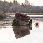 A large metal box floats in Ebey Slough on Tuesday, Nov. 21, 2023 in Everett, Washington. (Olivia Vanni / The Herald)