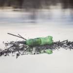 A Mountain Dew bottle floats in Ebey Slough on Tuesday, Nov. 21, 2023 in Everett, Washington. (Olivia Vanni / The Herald)
