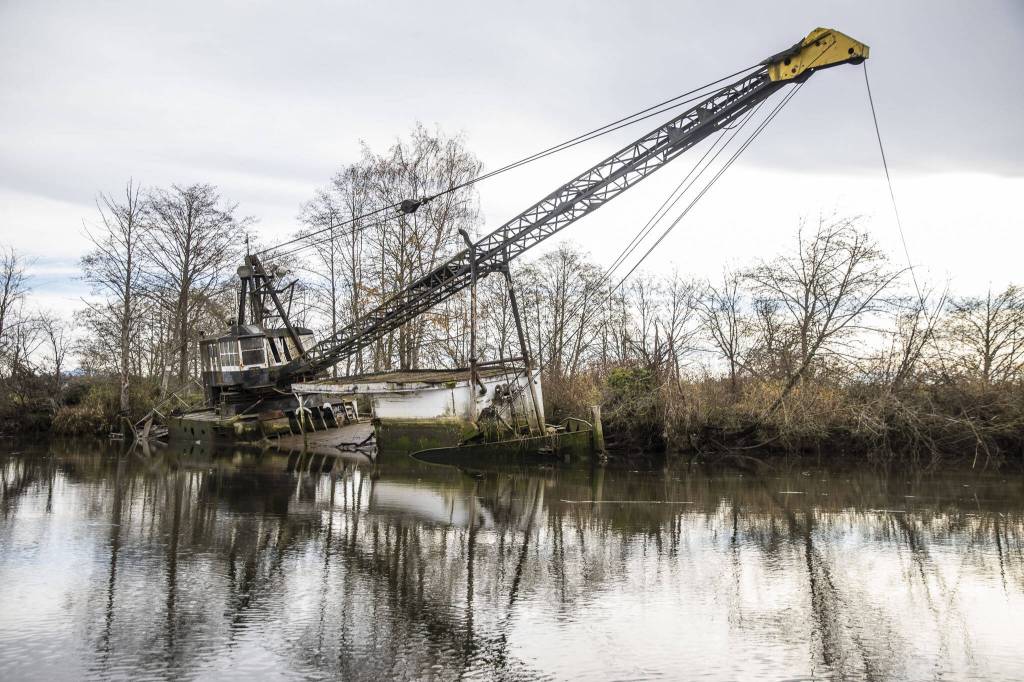 A derelict boat seen in Union Slough on Tuesday, Nov. 21, 2023 in Everett, Washington. (Olivia Vanni / The Herald)