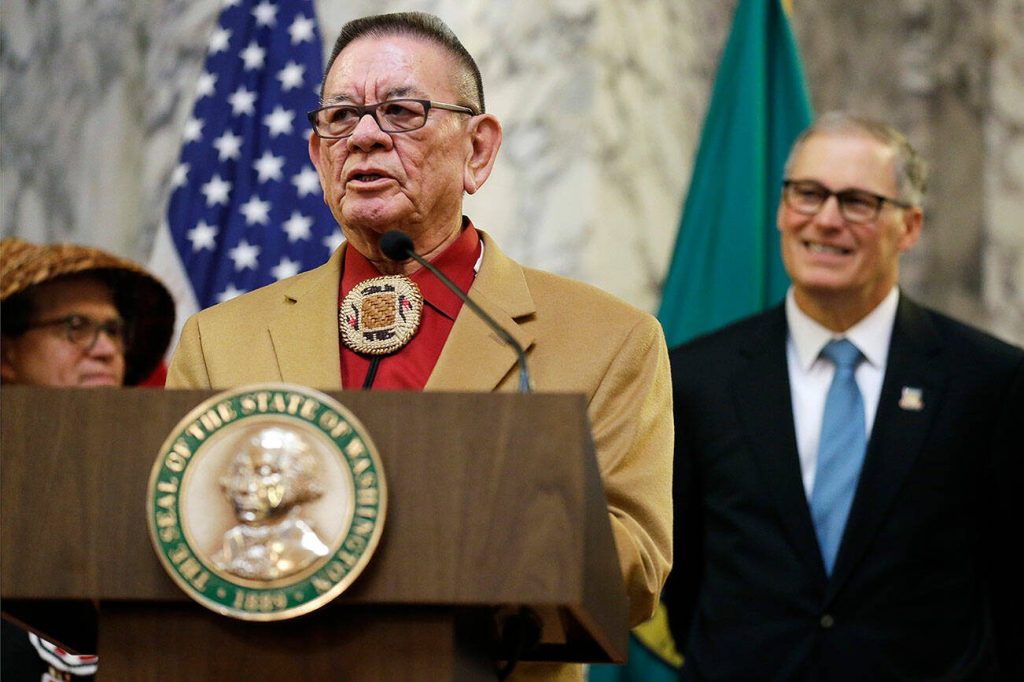 Sen. John McCoy, D-Tulalip, left, a member of the Tulalip Tribes of Washington, speaks Wednesday, Feb. 22, 2017, as Washington Gov. Jay Inslee, right, looks on at the Capitol in Olympia, Washington. (AP Photo/Ted S. Warren)