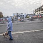 A person walks by the Broadway construction site of Compass Healths new mental health facility on Wednesday, Nov. 29, 2023 in Everett, Washington. (Olivia Vanni / The Herald)