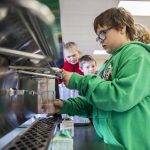 Darrington Elementary School fourth grader Brayden Parris, 9, fills up his cup with chocolate milk from one of the schools new milk dispenser during lunch on Monday, Nov. 20, 2023 in Darrington, Washington. (Olivia Vanni / The Herald)