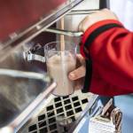 Darrington Elementary School students use a lever to fill up cups of milk from their schools milk dispensers on Monday, Nov. 20, 2023 in Darrington, Washington. (Olivia Vanni / The Herald)