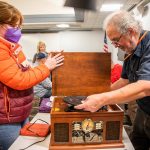 Clark Wood, right, starts repairs on a record player brought in to the Repair Cafe on Saturday, Nov. 18, 2023 in Mountlake Terrace, Washington. (Olivia Vanni / The Herald)
