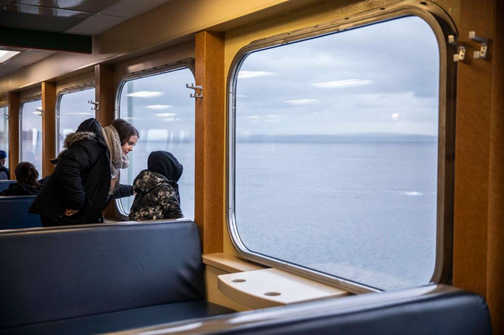 People look out the window from inside the M/V Kitsap on Friday, Dec. 1, 2023 in Mukilteo, Washington. (Olivia Vanni / The Herald)