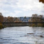Large logs flow quickly down the Snohomish River as the river reaches minor flood stage a hair over 25 feet following an overnight storm Saturday, Nov. 5, 2022, in Snohomish, Washington. (Ryan Berry / The Herald)
