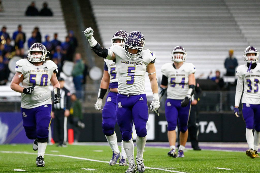 The Lake Stevens defense comes off the field after forcing a fourth quarter turnover on downs against Graham-Kapowsin during the WIAA 4A Football State Championship on Saturday, Dec. 2, 2023, at Husky Stadium in Seattle, Washington. (Ryan Berry / The Herald)
