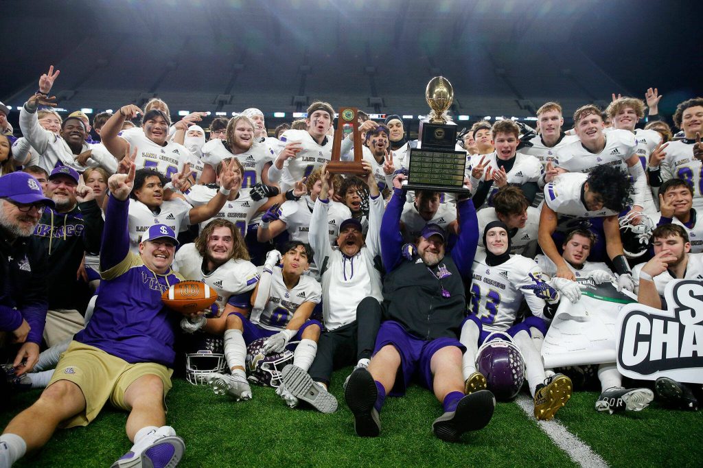 Lake Stevens joins together for a photo after their victory over Graham-Kapowsin in the WIAA 4A Football State Championship on Saturday, Dec. 2, 2023, at Husky Stadium in Seattle, Washington. (Ryan Berry / The Herald)