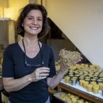 Katherine Hopke poses for a photo in her studio for Golden Light Beeswax Candles at her home in Everett, Washington on Thursday, Nov. 30, 2023.  (Annie Barker / The Herald)