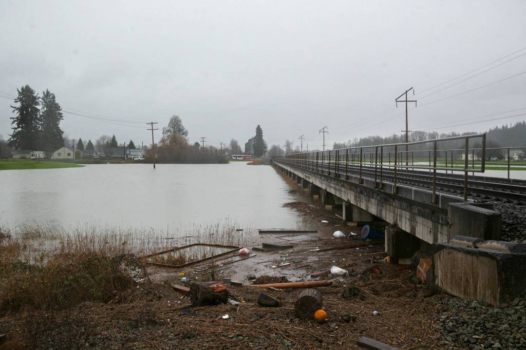 The fields around the traintrack at Ole Larson Road remain flooded on Thursday, Dec. 7, 2023, after extensive flooding from the Stillaguamish River in Silvana, Washington. (Ryan Berry / The Herald)