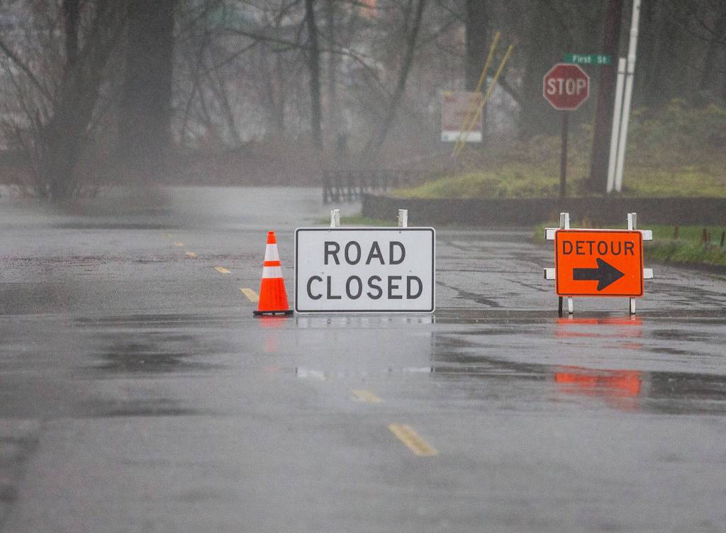 Road closures and detour signs direct people away from flooded roads on Tuesday, Dec. 5, 2023 in Sultan, Washington. (Olivia Vanni / The Herald)