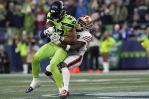 Seattle Seahawks tight end Noah Fant (87) gets tackled with the ball during an NFL football game against the San Francisco 49ers, Thursday, Nov. 23, 2023 in Seattle. The 49ers won 31-13. (AP Photo/Ben VanHouten)