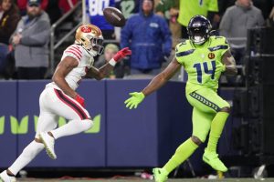 San Francisco 49ers cornerback Charvarius Ward, left, breaks up a pass intended for Seattle Seahawks wide receiver DK Metcalf (14) during the second half of an NFL football game, Thursday, Nov. 23, 2023, in Seattle. (AP Photo/Lindsey Wasson)