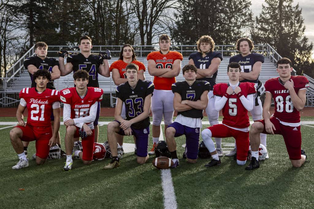 The Heralds All-Area first-team defense (Left to right, back row to front row) Gage Solomon (44), Mason Turner (54), Nick Mouser (15), Brennan Sheppard (88), Jeremy Fleming (11), Kobi Spady (37), Kenai Sinaphet (21), Max Mayo (18), David Brown (33), Gabe Kylany (7) Matthew Williams (5) and Jack Sievers (88) on Dec. 17 at Lake Stevens High School. Not pictured: Glacier Peaks Isaiah Cuellar. (Annie Barker / The Herald)