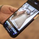 Dannika Prime shows a photograph of the standing water inside her bathroom on Tuesday, Dec. 12, 2023 in Silvana, Washington. (Olivia Vanni / The Herald)