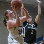 Arlingtons Katie Snow tries to make a layup while being guarded by Lynnwoods Kayla Lorenz during the game on Monday, Dec. 11, 2023 in Arlington, Washington. (Olivia Vanni / The Herald)