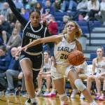 Arlingtons Samara Morrow drives to the hoop while being guarded by Lynnwoods Teyah Clark during the game on Monday, Dec. 11, 2023 in Arlington, Washington. (Olivia Vanni / The Herald)