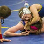 An Everett wrestler gets her opponent in a headlock on Wednesday, Dec. 13, 2023 in Everett, Washington. (Olivia Vanni / The Herald)
