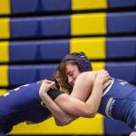 Arlingtons Danielle Crew tries to snap down the head of her opponent on Wednesday, Dec. 13, 2023 in Everett, Washington. (Olivia Vanni / The Herald)