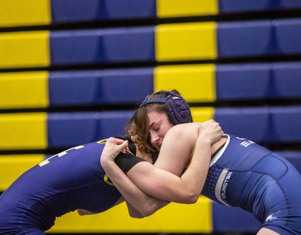 Arlingtons Danielle Crew tries to snap down the head of her opponent on Wednesday, Dec. 13, 2023 in Everett, Washington. (Olivia Vanni / The Herald)